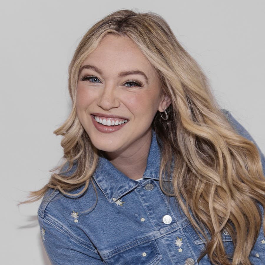 Isabel Brown smiling in a denim jacket